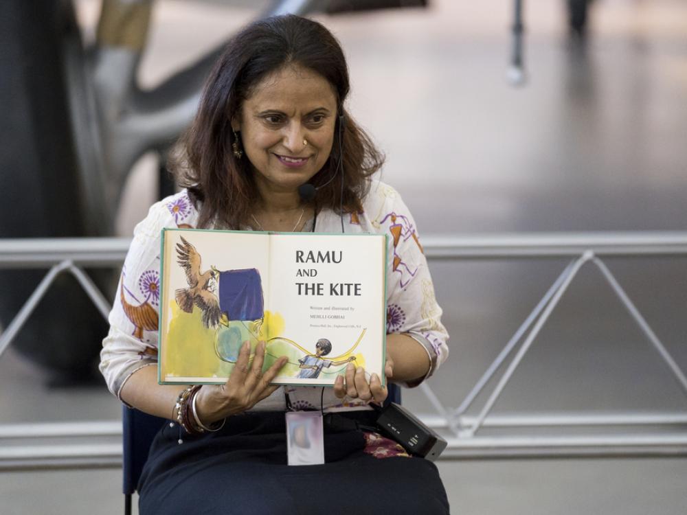 An educator reads a storybook. 