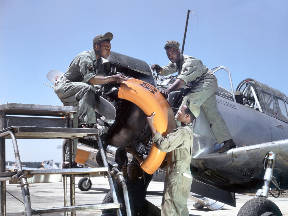 Mechanics at Tuskegee Army Air Field maintain an engine of a Vultee BT-13A Valiant